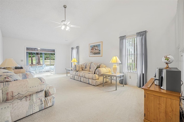 living room featuring ceiling fan, carpet floors, a textured ceiling, and high vaulted ceiling