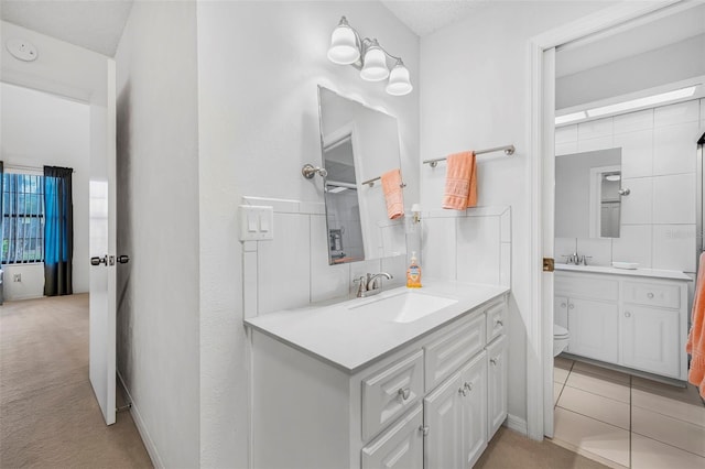 bathroom with tile patterned floors, vanity, and toilet