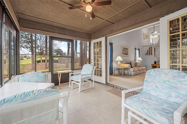 sunroom / solarium featuring wooden ceiling and ceiling fan