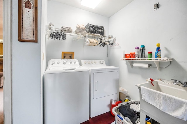 laundry area featuring washing machine and dryer and sink