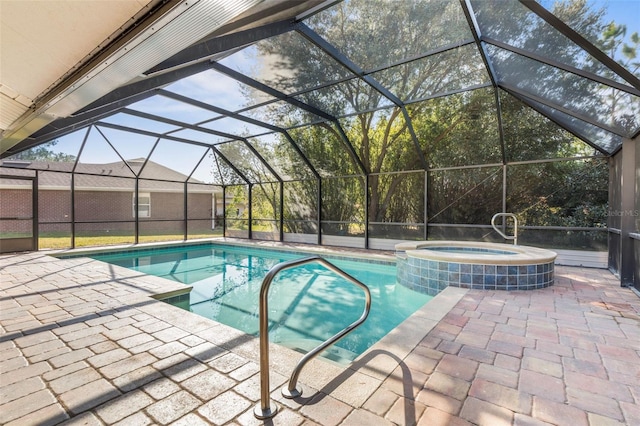 view of swimming pool with an in ground hot tub, a lanai, and a patio area