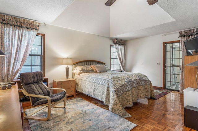 bedroom with vaulted ceiling, dark parquet floors, and a textured ceiling