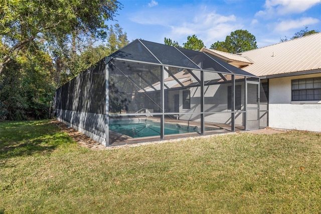 back of property featuring a fenced in pool, a yard, and glass enclosure