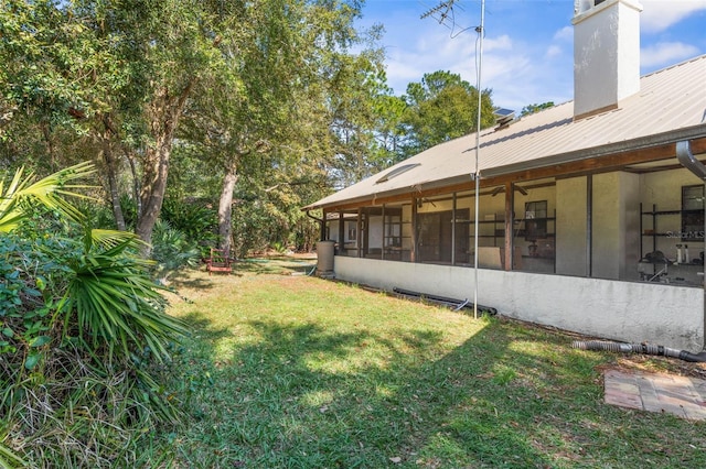 view of yard featuring a sunroom