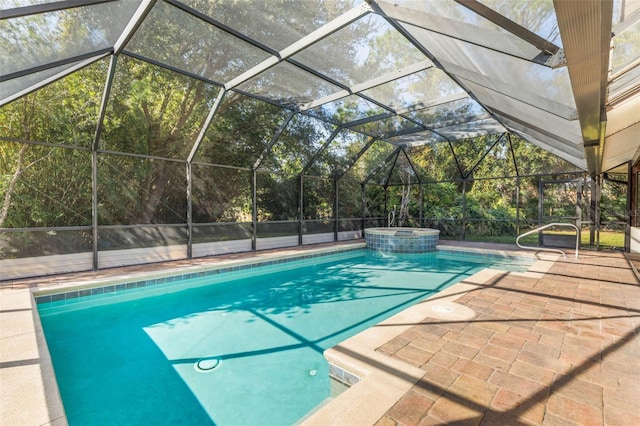 view of pool with a patio, a lanai, and an in ground hot tub