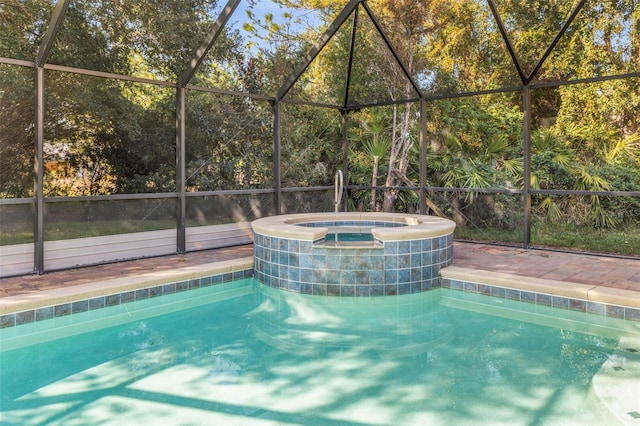 view of pool with an in ground hot tub, central AC, and glass enclosure