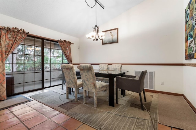 tiled dining room with lofted ceiling and a notable chandelier