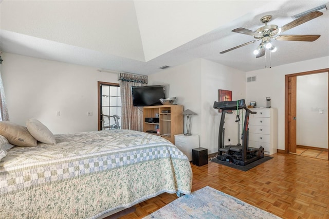 bedroom featuring ceiling fan, parquet flooring, and a textured ceiling