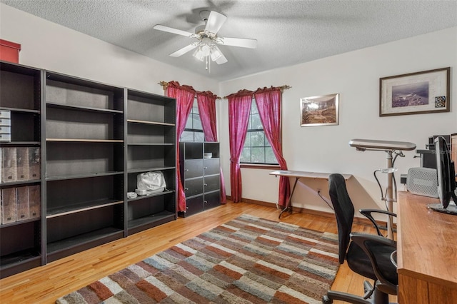 office space with ceiling fan, wood-type flooring, and a textured ceiling