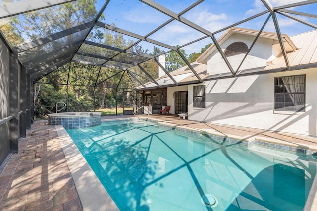 view of pool with an in ground hot tub, a lanai, and a patio