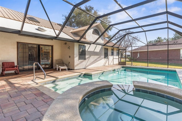 view of pool featuring a lanai, a patio area, and an in ground hot tub