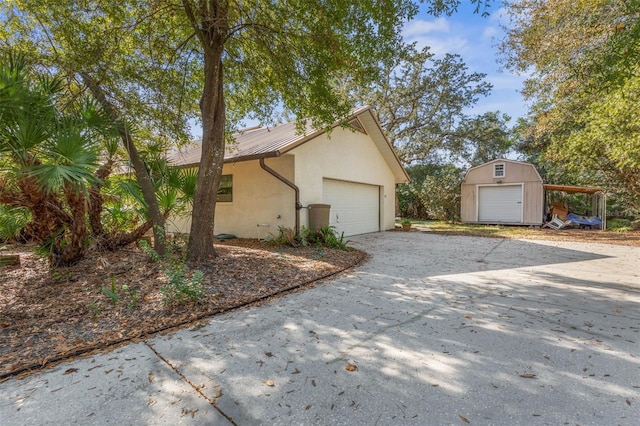 view of home's exterior featuring a storage shed and a garage