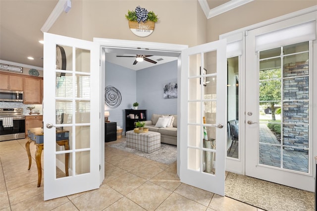 doorway to outside with light tile patterned floors, crown molding, french doors, and ceiling fan