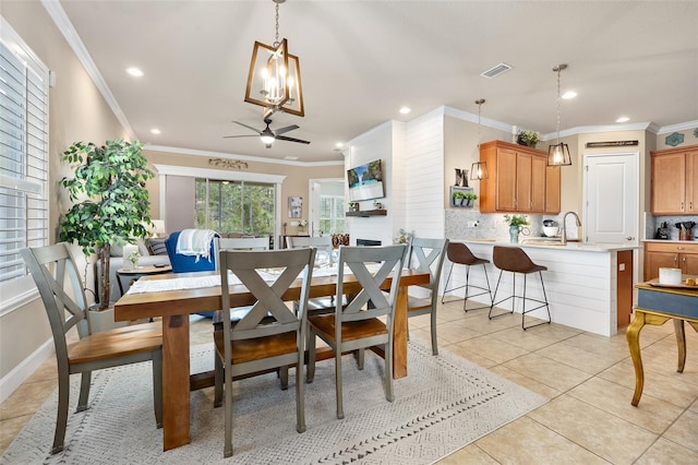 dining area featuring light tile patterned floors, ornamental molding, and ceiling fan