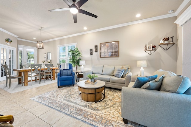 tiled living room with french doors, ceiling fan, and ornamental molding