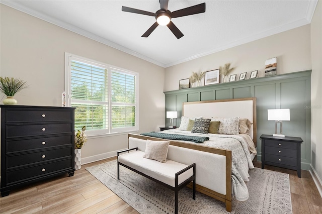 bedroom featuring ornamental molding, ceiling fan, and light hardwood / wood-style floors