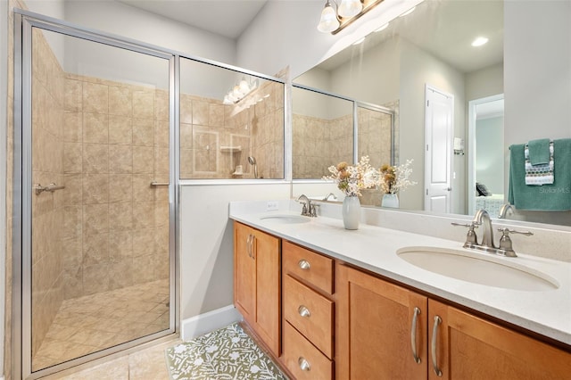 bathroom featuring tile patterned flooring, vanity, and an enclosed shower