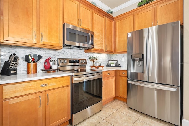 kitchen with backsplash, ornamental molding, stainless steel appliances, and light tile patterned flooring