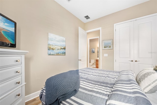 bedroom with hardwood / wood-style flooring and a closet