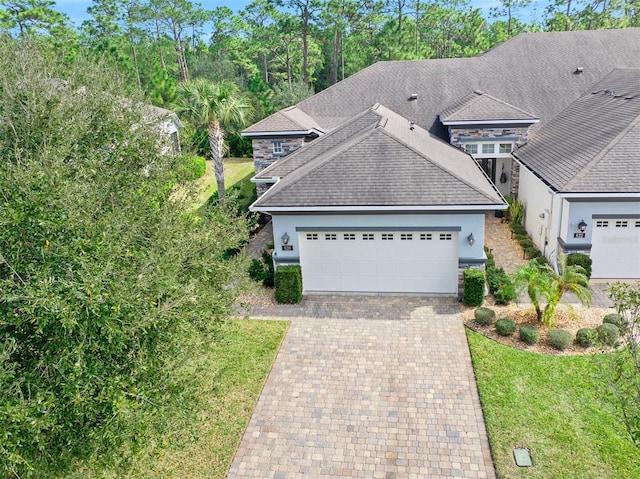 view of front of property featuring a garage and a front lawn