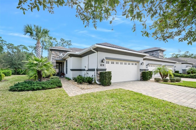 view of front of property featuring a garage and a front lawn