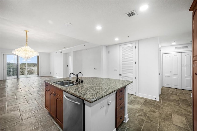 kitchen with sink, hanging light fixtures, stainless steel dishwasher, a notable chandelier, and a kitchen island with sink