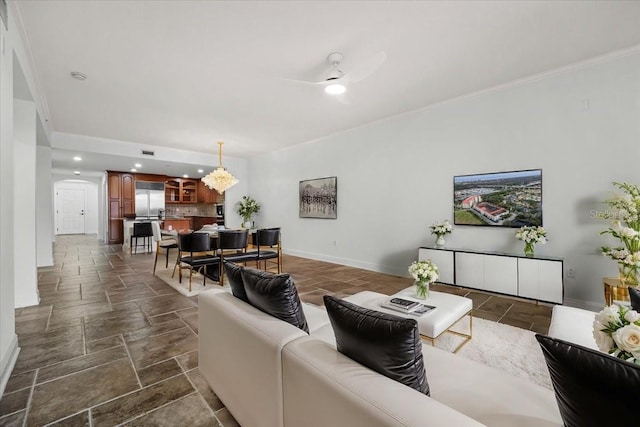 living room with crown molding and ceiling fan