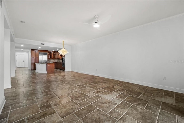 unfurnished living room with ceiling fan with notable chandelier