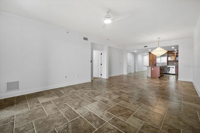 unfurnished living room featuring wine cooler and ceiling fan with notable chandelier