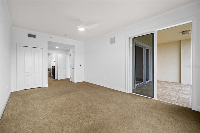 interior space with ornamental molding and ceiling fan