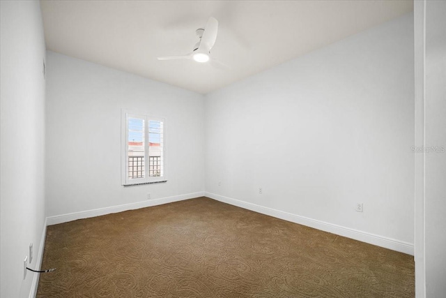 carpeted spare room featuring ceiling fan