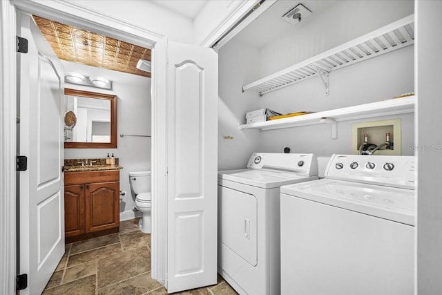 laundry area featuring washer and dryer and sink