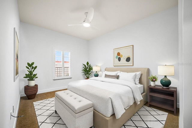 bedroom featuring a ceiling fan, light colored carpet, and baseboards
