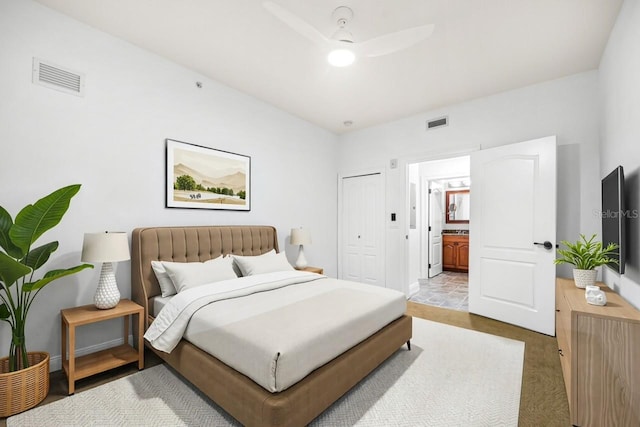 bedroom featuring visible vents, baseboards, ensuite bath, and a closet