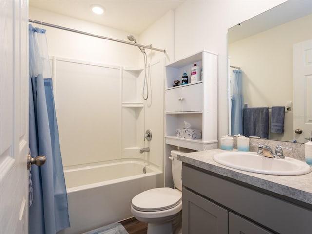 full bathroom with vanity, hardwood / wood-style floors, shower / tub combo, and toilet