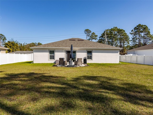 rear view of house featuring a lawn