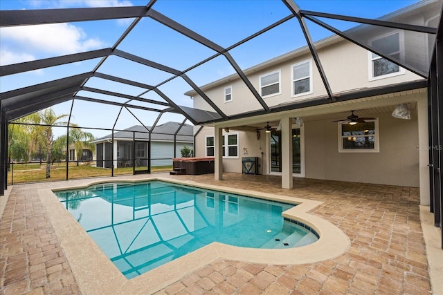 view of swimming pool with a hot tub, a patio, a lanai, and ceiling fan