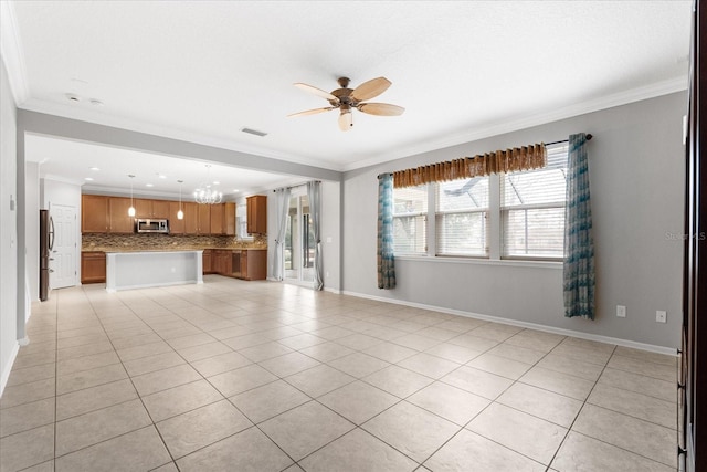 unfurnished living room with crown molding, ceiling fan with notable chandelier, and light tile patterned floors