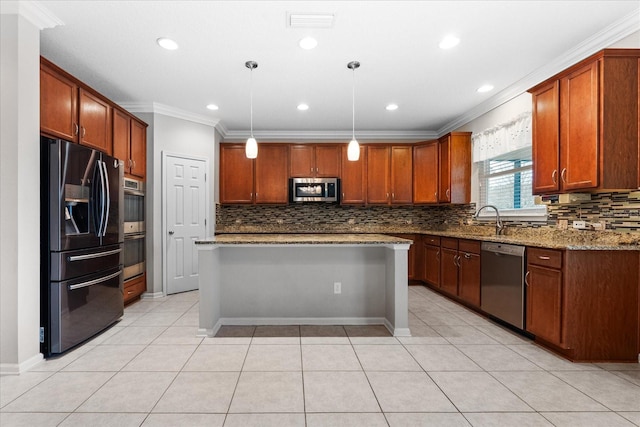 kitchen featuring pendant lighting, light stone counters, a center island, and appliances with stainless steel finishes