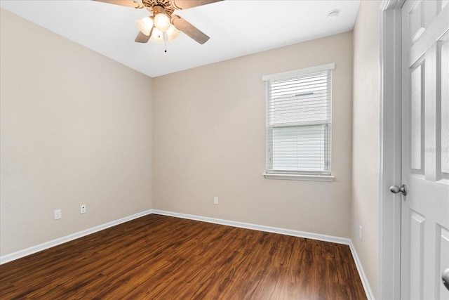 spare room with dark hardwood / wood-style flooring and ceiling fan