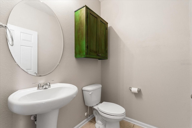 bathroom with tile patterned floors, toilet, and sink