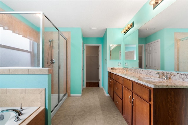 bathroom with plus walk in shower, vanity, and tile patterned floors