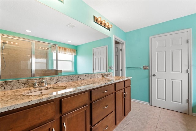 bathroom with vanity, tile patterned floors, and a shower with shower door