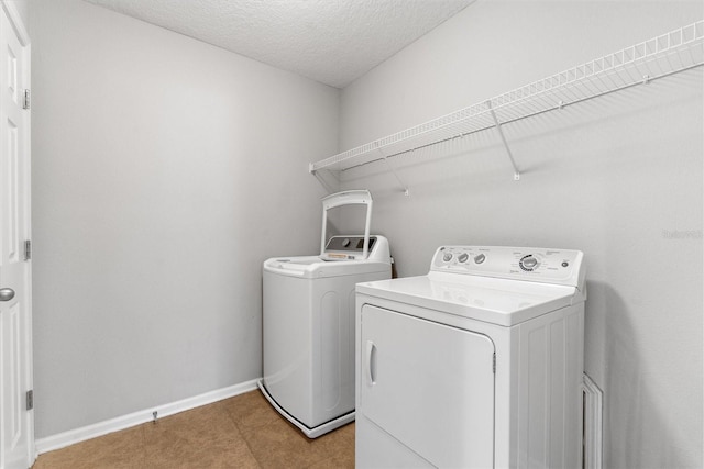 washroom featuring washer and dryer and a textured ceiling