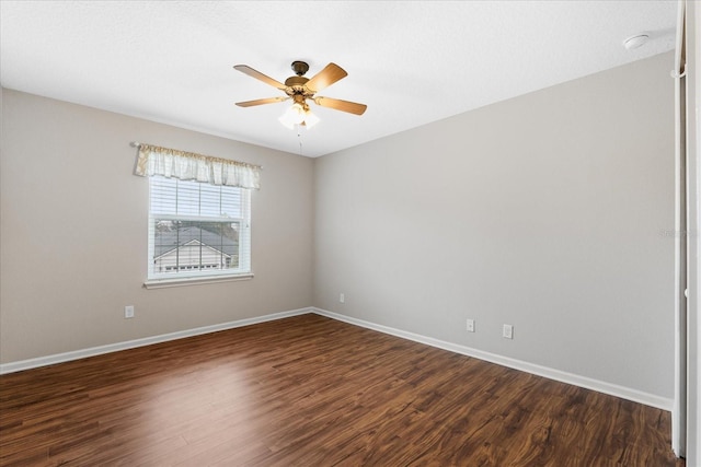 unfurnished room with ceiling fan and dark hardwood / wood-style flooring