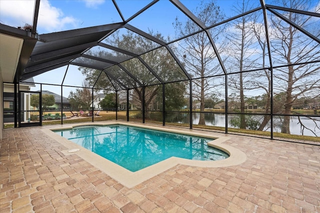 view of swimming pool featuring a patio, a water view, and glass enclosure