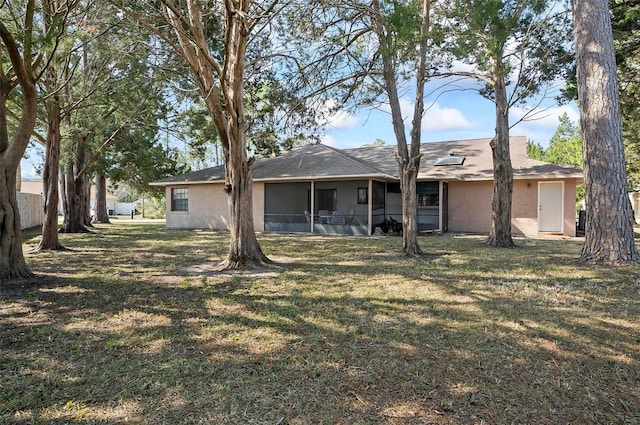 back of house featuring a lawn