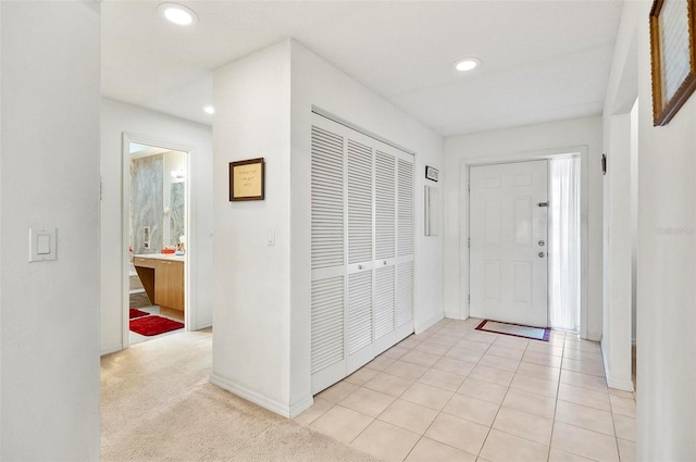 view of carpeted foyer entrance