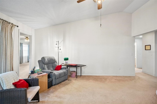 living area with ceiling fan, vaulted ceiling, and light carpet