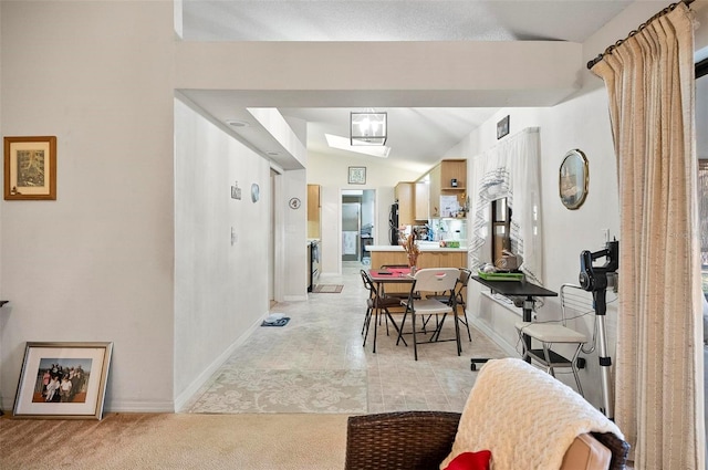 dining area featuring lofted ceiling